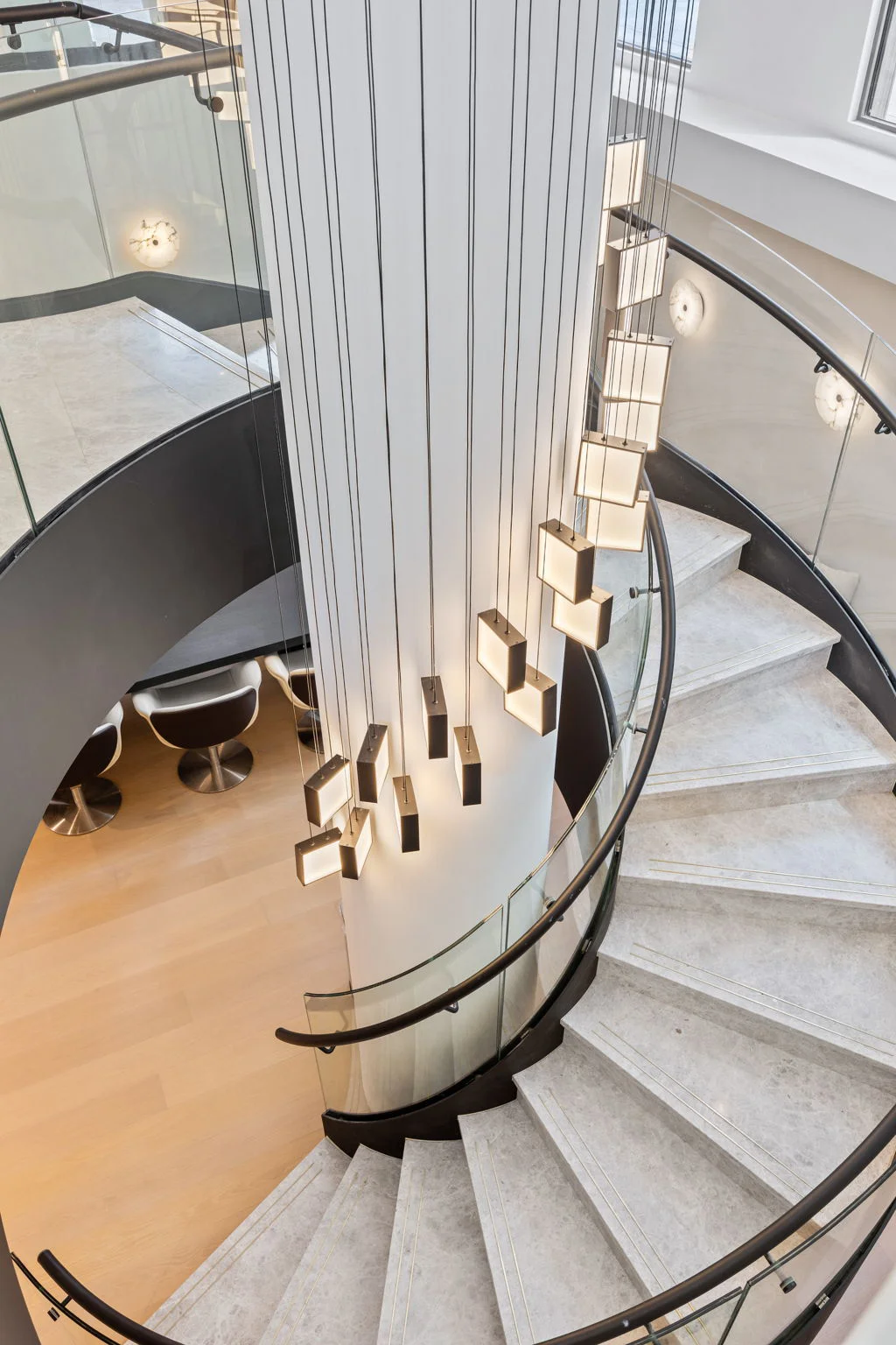 A grand spiral staircase leads to a lower level coworking space that includes conference rooms.